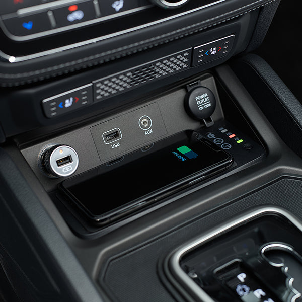 This is a completely authentic accessory designed to elevate your driving experience by offering an integrated, effortless solution for charging your devices while you're on the move.  This charger takes the place of the factory tray beneath the USB ports in your centre console, ensuring a neat and tidy appearance while introducing contemporary functionality.